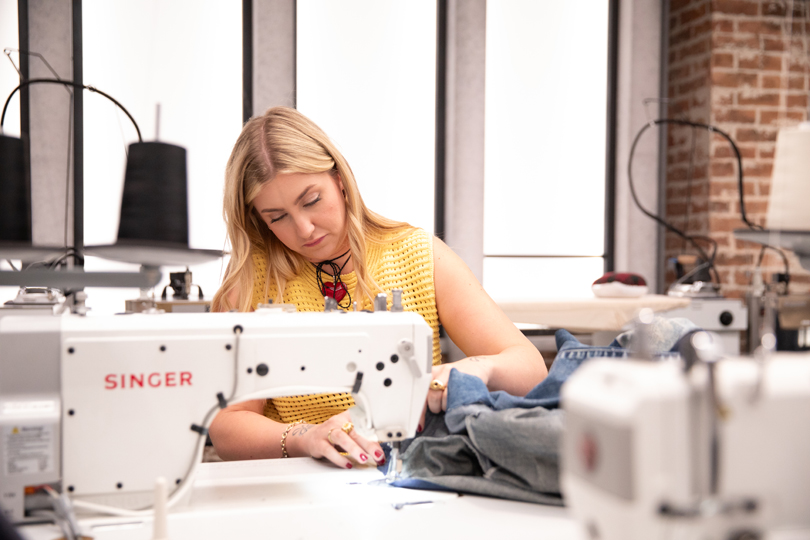 Project Runway Canada Seamlessly Struts Back With New Season - Naomi sewing in the workroom